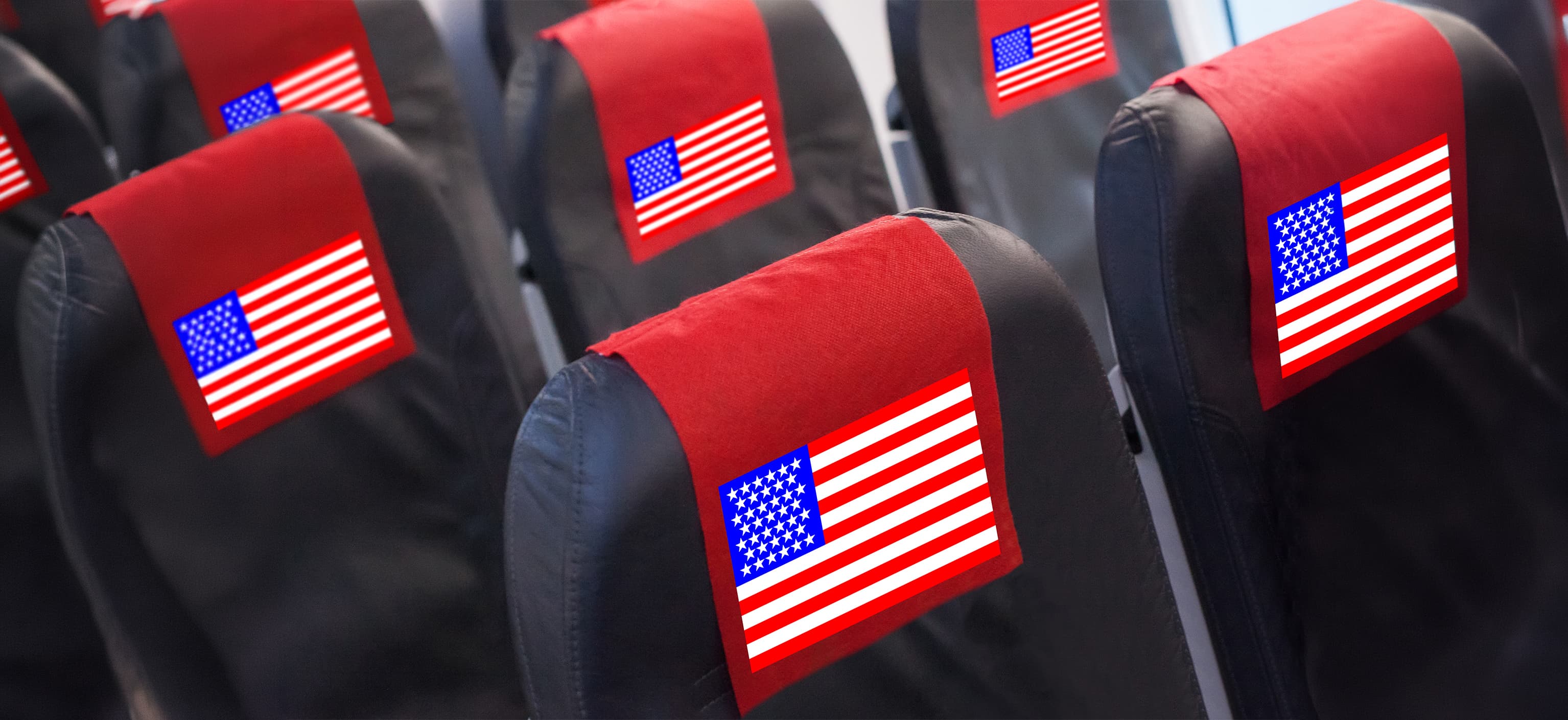 Row of airplane seats with American flag headrest covers