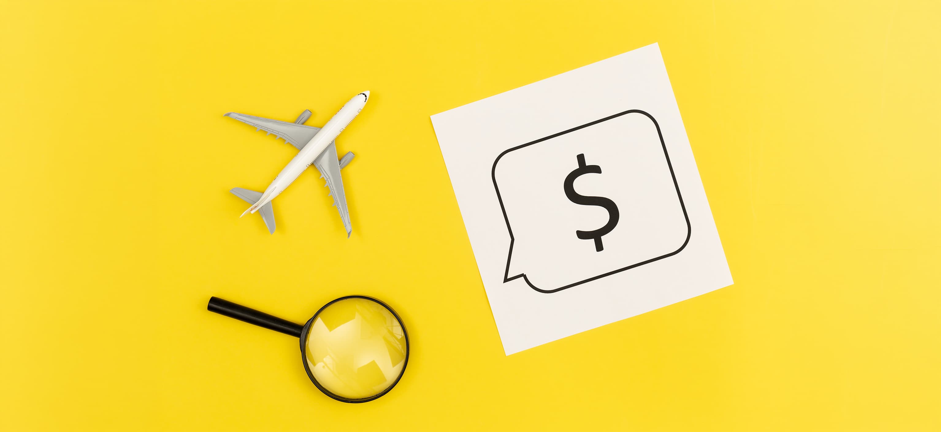 Toy airplane, magnifying glass, and a dollar-sign speech bubble